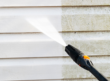 Pressure wash the exterior of your house siding to remove dirt and mildew build up.